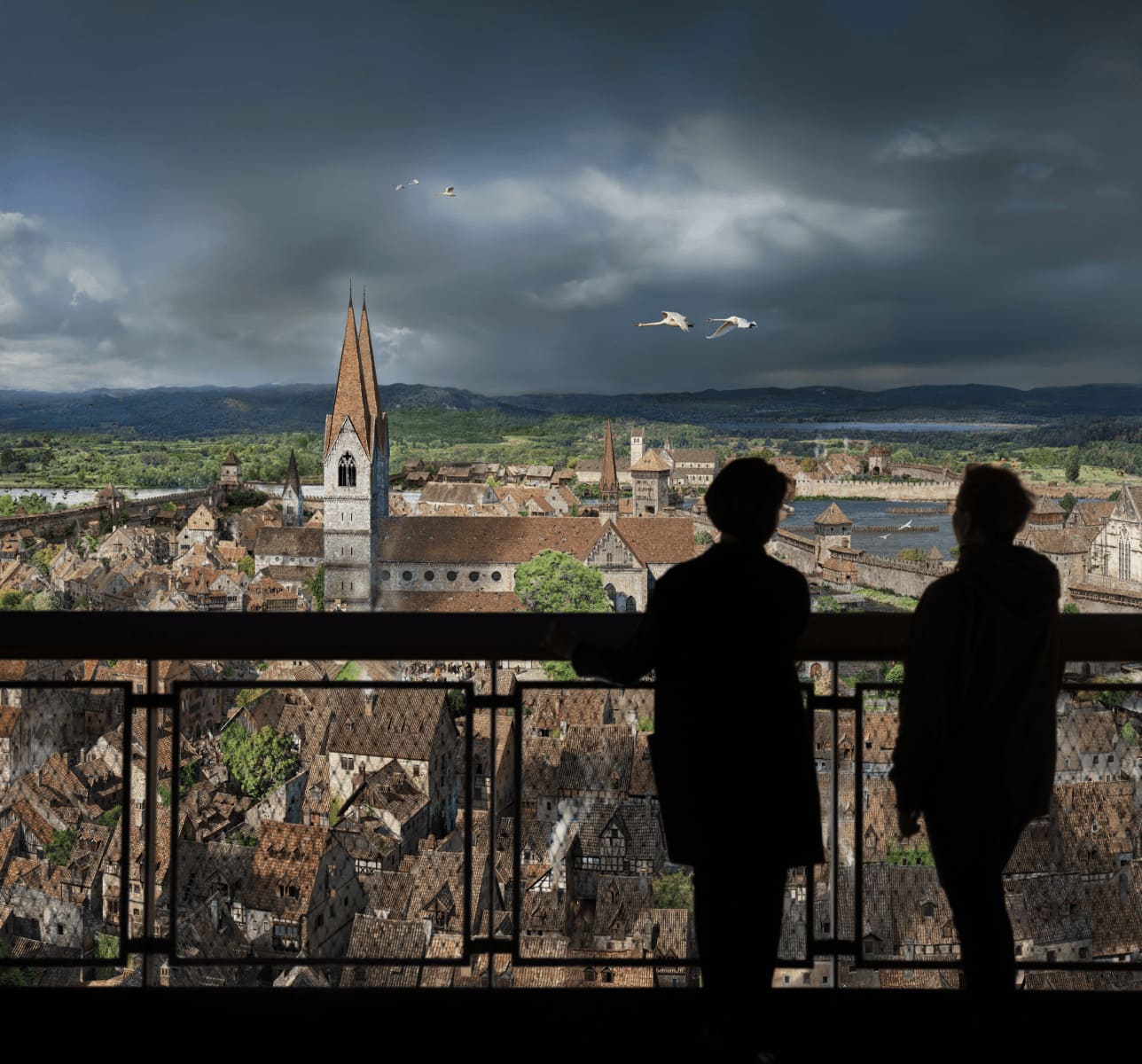 People looking down from the tower at medieval Constance